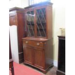 A Regency mahogany secretaire bookcase of small dimensions, the base enclosed by a pair of