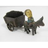 Late 19th century continental metal pen wipe in the form of a small child riding a donkey pulling