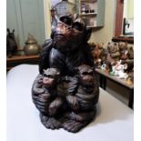 A carved timber figure of a mother monkey and two babies, 42cm high