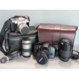 A Pentax MZ-50 and Minolta Dynax 500SI Super both with two lenses in camera bags