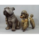 Pottery figure of a recumbent Bulldog, further example of a French Poodle, 37 cm in height and