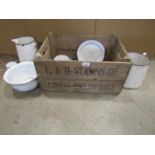 A small collection of vintage cream blue rimmed enamel ware housed within a wooden crate with