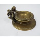 An unusual Victorian brass bowl, to one side an adult and child monkey, the larger holding a