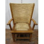 An Orkney chair - mid 20th century, in oak with straw work canopy back, makers stamp DM Kirkness