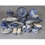 A collection of blue and white printed wares including a Booths Willow pattern drainer and bowl,