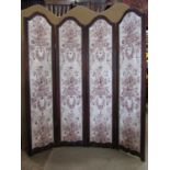 A freestanding four fold screen the stained wooden surround enclosing arched faux leather