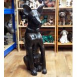 A large carved hardwood timber figure of a seated hound, 80cm high