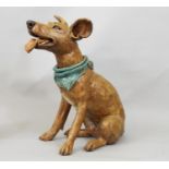 A studio pottery figure of a terrier wearing a scarf, in seated pose, by Joanna Cooke, 32cm high