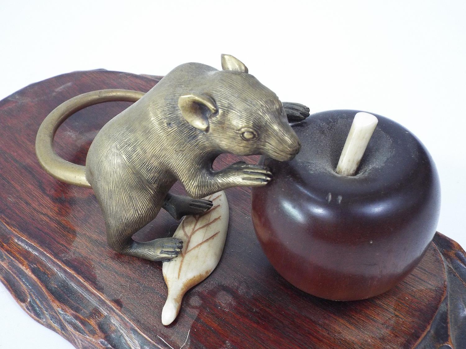 A Japanese group comprising a brass rat with gold tail, about to eat an apple, in turned wood, - Image 3 of 4