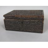 Antique hardwood casket with various carved decoration, 25cm wide (af)