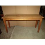 A good quality narrow light oak side table of rectangular form with moulded outline and rounded