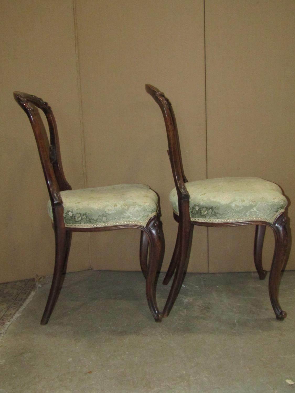 A pair of Victorian walnut balloon back dining chairs with carved foliate detail, serpentine - Image 2 of 3