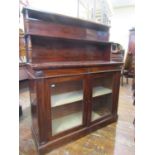 A regency mahogany chiffonier, the lower section enclosed by glazed panel doors, the upper section
