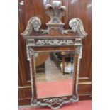 A large wall mirror in a George II style, the walnut frame with additional gilded borders and