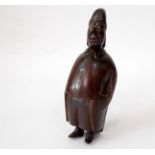 A 19th century carved snuff box in the form of a rotund male character wearing a night cap, 10cm