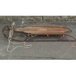 A vintage Lillywhites of Piccadilly, London toboggan with traces of original painted detail