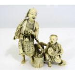 A Japanese ivory Okimono of two fishermen with their catch, one resting upon an anchor, with