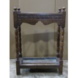 A 1920s oak three divisional umbrella/stickstand of rectangular form with turned bobbin supports and