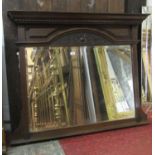 An Edwardian overmantle mirror with rectangular bevelled edge plate within a moulded frame with