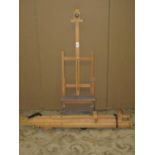 A small Winsor & Newton beechwood artists easel with adjustable folding framework together with
