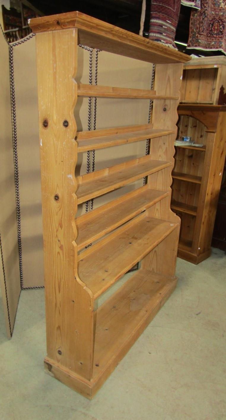 A stripped pine floorstanding open waterfall style bookcase with fixed shelves and shaped outline, - Image 2 of 2
