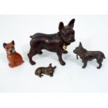 A bronze figure of a Boston terrier, three further examples in various materials, 11 cm in length