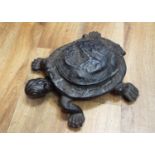 An unusual Victorian cast iron spittoon in the form of a tortoise, the head when pressed raises