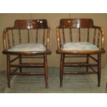 A pair of early 20th century ashwood bow and spindleback office chairs with upholstered pad seats