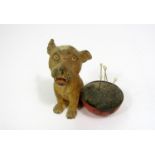 A spelter pin cushion - Bonzo, accompanying an upturned bowl forming the pin cushion, 8 cm in height