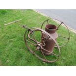 An old wrought iron milk churn hand cart with spoke wheels complete with an old Co-op Society