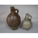 An 18th century stoneware Bellarmine type jug with mask detail to neck, with old repairs, 22cm