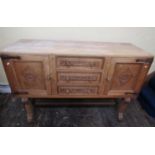 A good quality fumed oak sideboard, the tower of three central drawers flanked by two cupboards