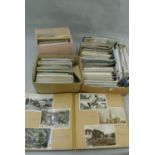 An album containing a collection of black and white and colour mixed topographical postcards,