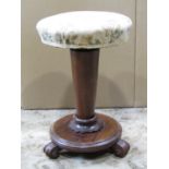 A Victorian rosewood music stool with circular revolving adjustable upholstered seat raised on a