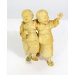 Taisho Period - Ivory Okimono of two happy boys, entwined arms, walking forward, 13cm