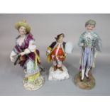 Three 19th century continental ceramic figures of a female hurdy gurdy player in chinoiserie style