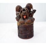 Late 19th century carved timber box in the form of a cylindrical basket crammed with three Lhasa