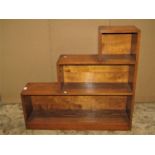 An Art Deco style low oak open bookcase of stepped form together with a pair of framed and glazed