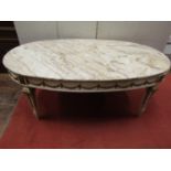 A low cream painted and gilt moulded highlighted occasional table of oval form with classical