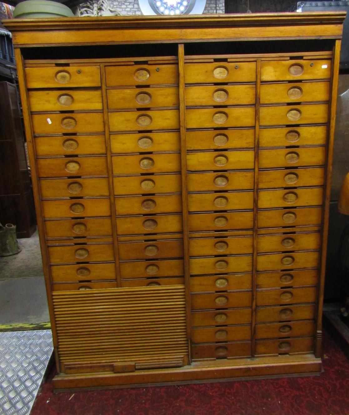 An early 20th century oak floorstanding filing cabinet fitted with a segmented tower arrangement