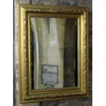 A 19th century deep moulded re-gilded rectangular frame with leaf, berry and further detail and