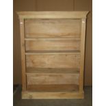 A Victorian stripped pine dwarf floorstanding open bookcase with two adjustable shelves set on a