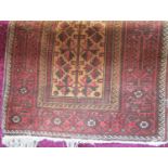 Persian rug with geometric leaf decoration in red and black on a fawn ground, 180 x 100cm