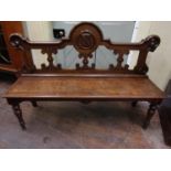 A Victorian hall bench, the solid timber seat raised on a turned forelegs, the shaped and pierced