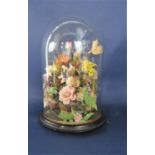 Vintage floral diorama under a glass dome with ebonised plinth stand, 37 cm high