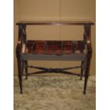 A reproduction Regency style hardwood floorstanding book trough/stand raised on ring turned and