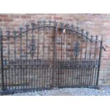 A pair of good quality heavy gauge cast iron entrance gates of stepped arched form with fleur-de-lys