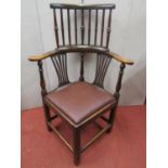 A Georgian country made elbow chair principally in ashwood with carved and pierced splats, the upper