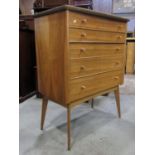 An Alfred Cox walnut bedroom chest of five long graduated drawers with cone shaped handles and