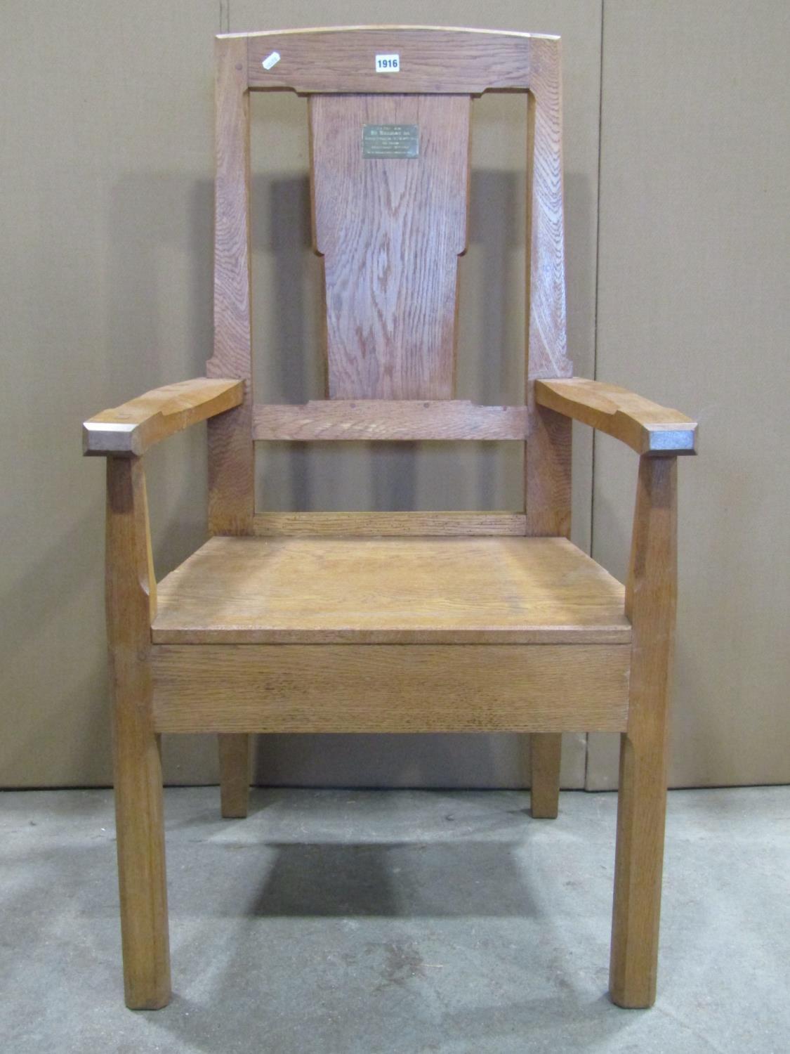 An oak open armchair with chamfered frame, solid seat, through jointed arms and broad splat, with - Image 2 of 4